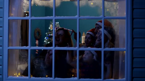 happy family watching fireworks through window