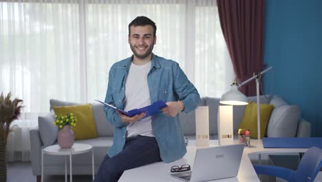 cheerful real estate agent looking at camera with house key and contract papers.