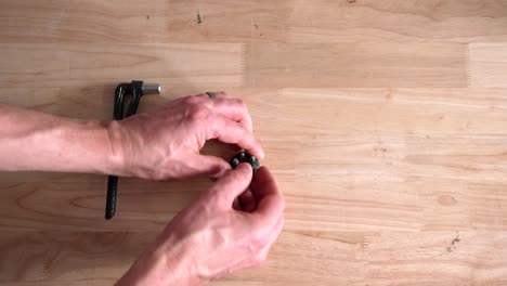 topdown view of hands putting hex key bit in torque wrench tool