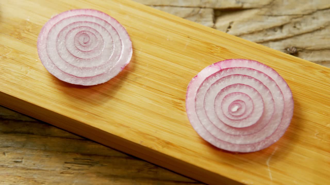 Sliced onions arranged on a wooden board 4k