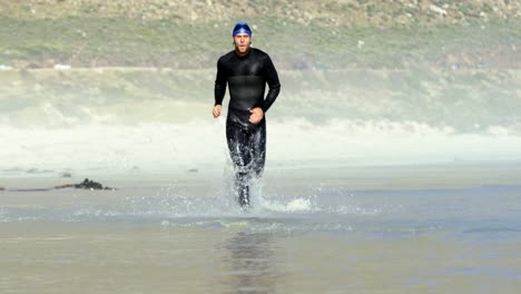 male surfer running in the beach