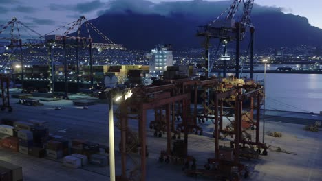 4k-Drone-Shot-of-Table-Bay-Harbour-steel-Containers-and-Gantry-Cranes-with-Table-Mountain,-Cape-Town-In-The-Background