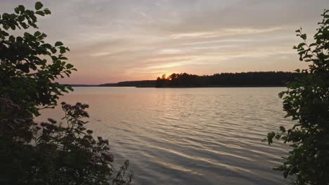 golden sunset over calm wdzydze lake in poland - wide shot timelapse