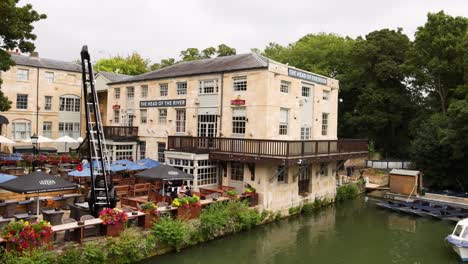 boat passing by a riverside restaurant