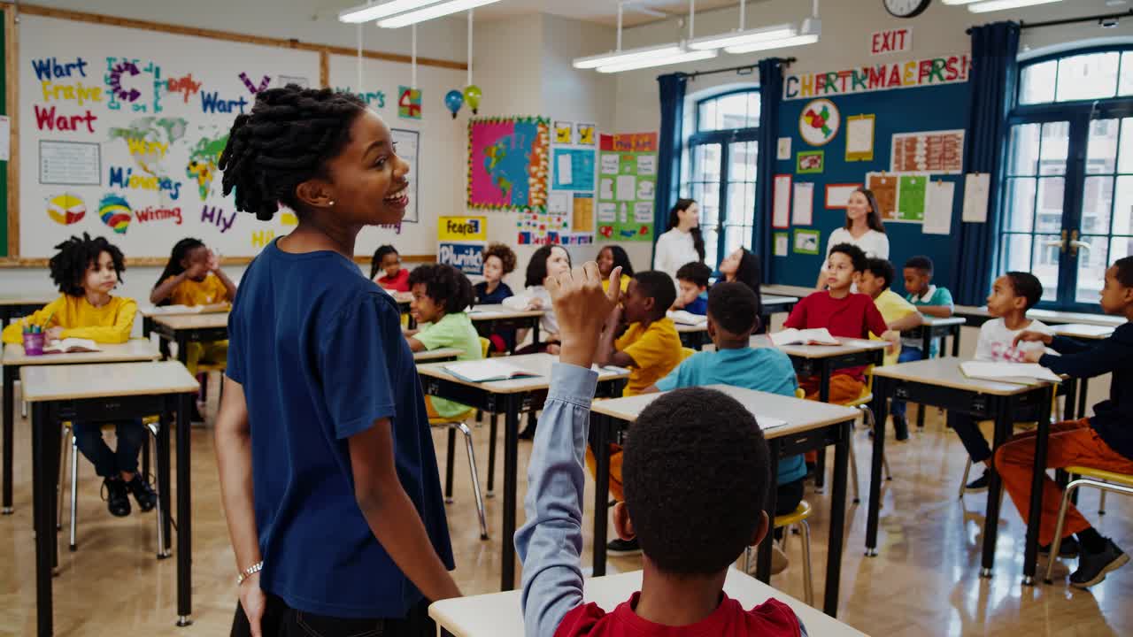 Wide-angle video shot of a vibrant classroom with students in colorful outfits, showcasing a lively