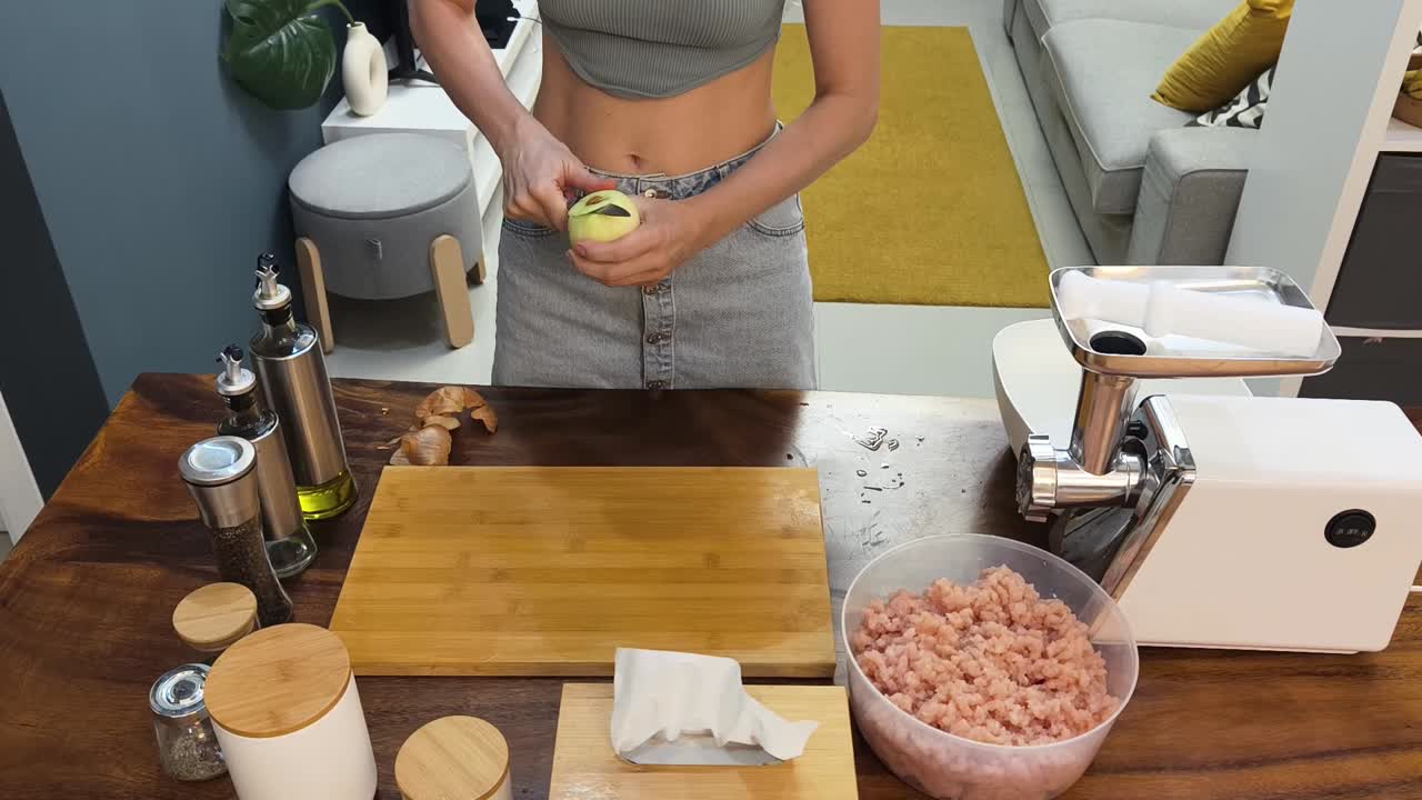 Woman preparing food with a meat grinder