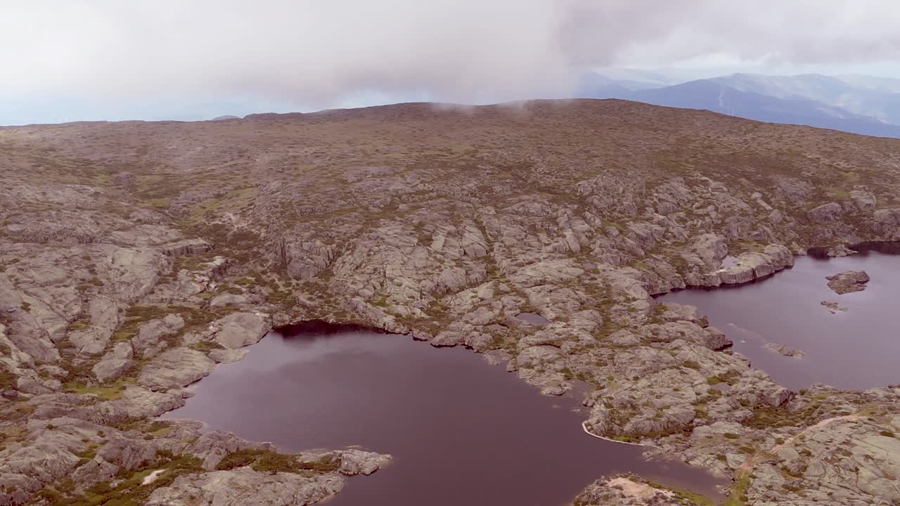 A capture of a broad landscape perspective showcasing the formation of a lake within Portugal's Serra de Estrella