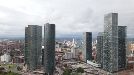 aerial view circling deansgate manchester tall contemporary glass window skyscrapers and downtown cityscape