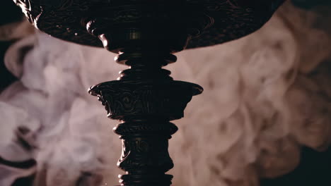 close-up of a hookah bowl with smoke