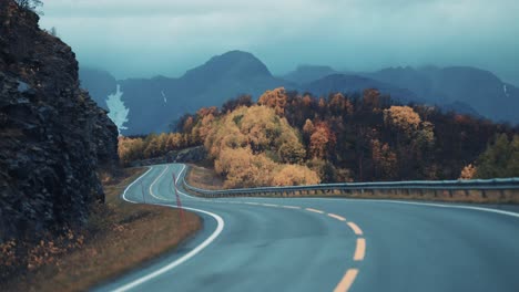 the two-lane road leading through the northern autumn landscape