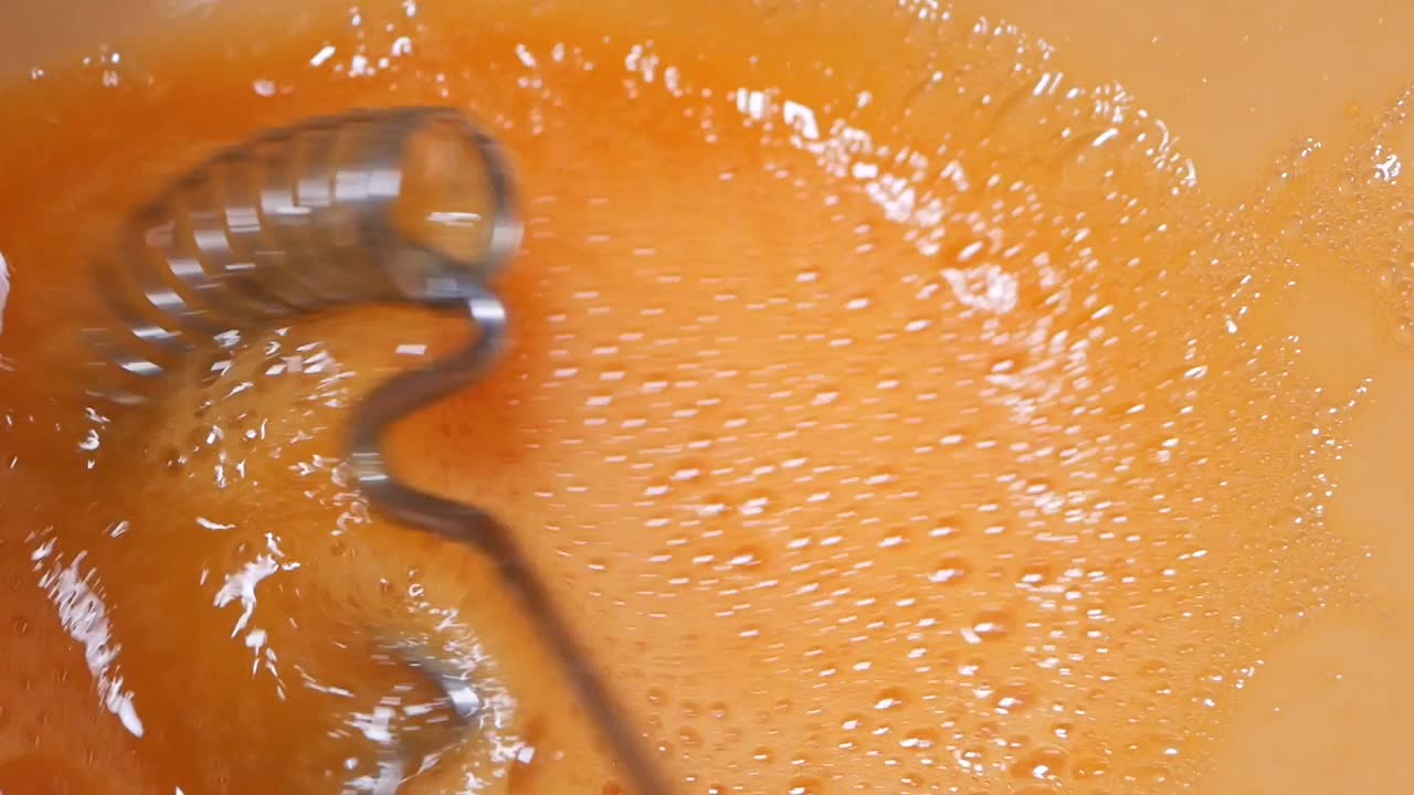 Mixing Orange Liquid with Beater