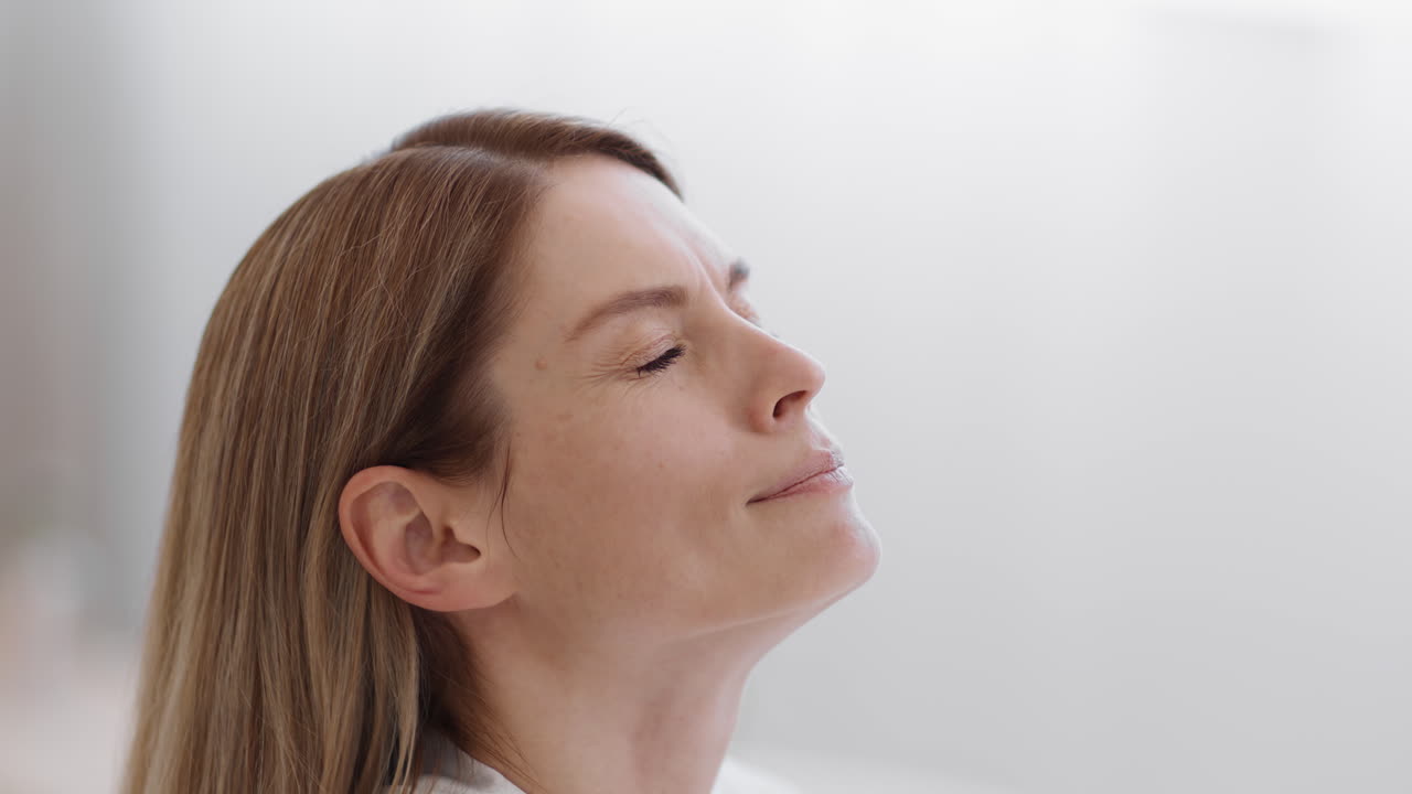 A woman looking up with various expressions, including applying a nasal spray