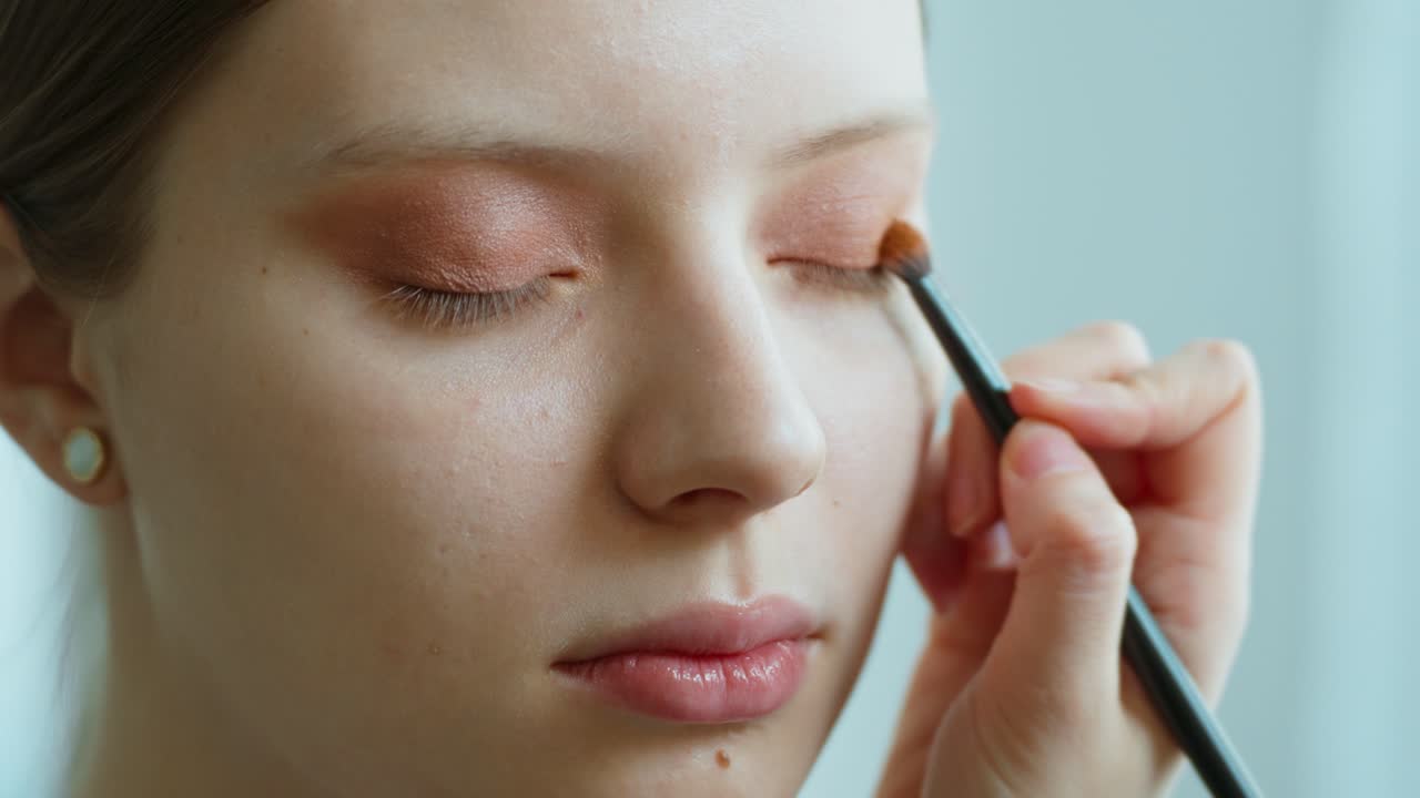 Woman getting eyeshadow applied