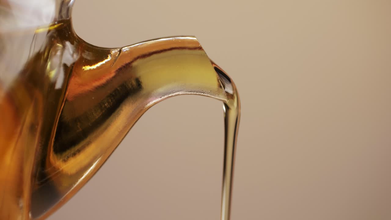 Pouring Oil from a Glass Teapot