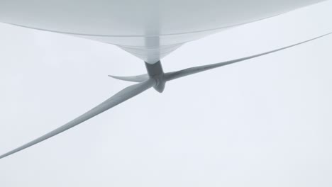 wind turbine blades turning low angle perspective