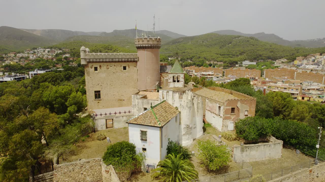 Aerial View of a Historic Stone Castle and Surrounding Town