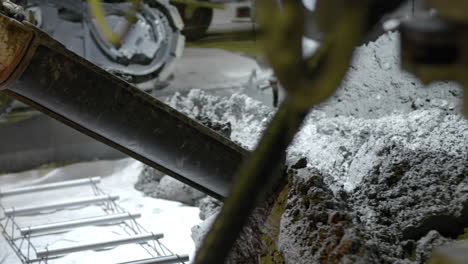 Pouring-cement-from-the-mixer-down-the-chute---isolated-slow-motion