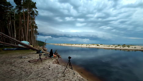 camping by the baltic sea lagoon, videographer camera set-up, behind the scene