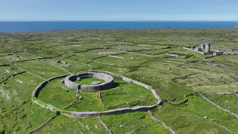 ancient prehistoric fort on inis more aran islands with the blue atlantic ocean and tiny fields enclosed by dry stone walls on the wild atlantic way