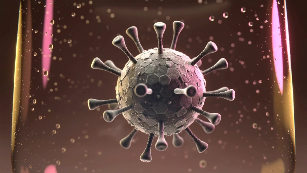 Particella Rotante Simile a un Virus all'Inizio che Rivela un Guscio Esagonale in una Fiala da Laboratorio, con Microbolle che Salgono