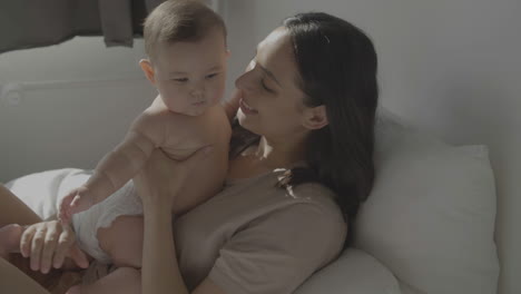 Mom-Kissing-And-Lifting-Her-Cute-Baby