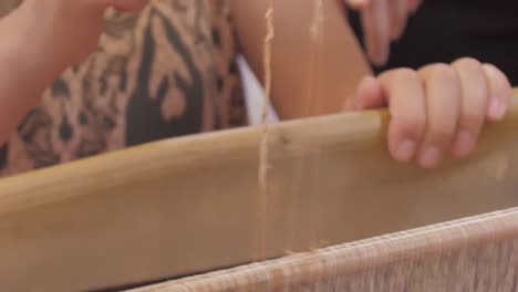 woman weaving silk cu