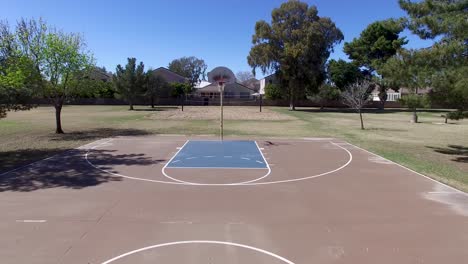 Drone-footage-of-Scottsdale-city-park,-basketball-court-pan-across-the