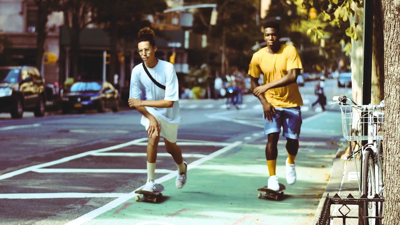 Two Young Men Skateboarding and Hanging Out in the City