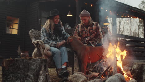 Couple-Petting-Dog-by-Bonfire