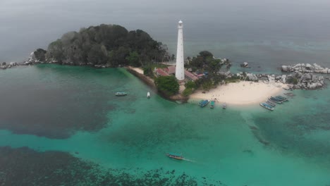 reveal shot of lengkuas island belitung with lighthouse and boat, aerial