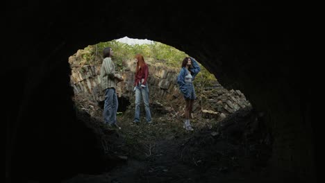 friends exploring abandoned tunnel