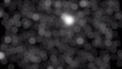 hermoso flujo hacia abajo moviendo burbujas bokeh blancas luces movimiento de bucle sin costuras en fondo negro. partícula pastel en bucle de fondo negro.