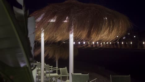 view for outdoor chalet in front of the beach at night, close up shot, push in shot