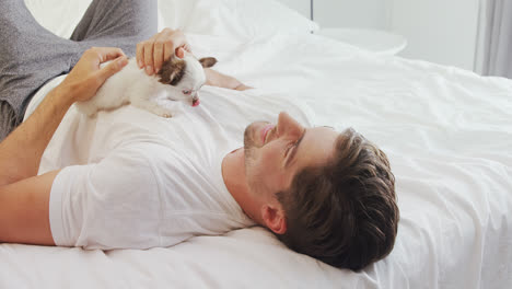 happy young man lying on bed stroking his puppy 4k 4k