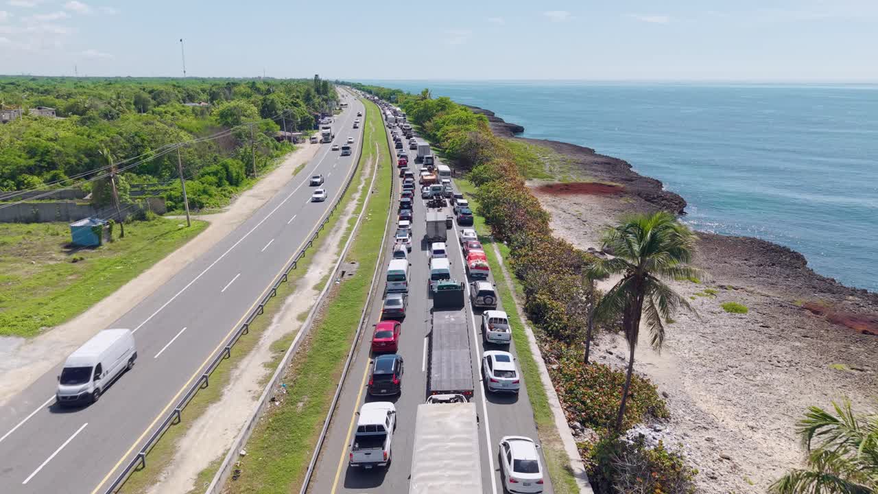 Traffic jam on Las Américas Highway, Caribbean coast, Dominican Republic. Aerial forward