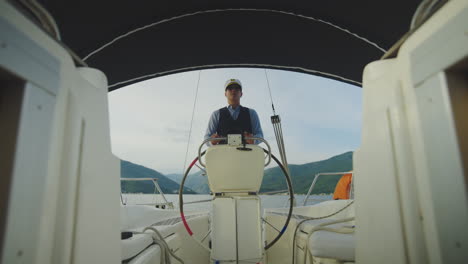 captain steering a yacht