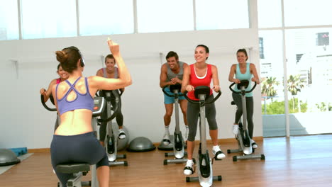 spin class working out with instructor