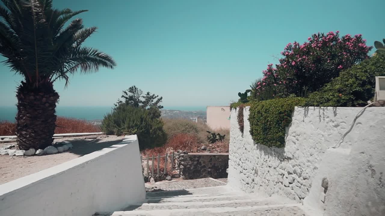 Revealing clip of the horizon in a pebble stone road in a Greek Island during Summer