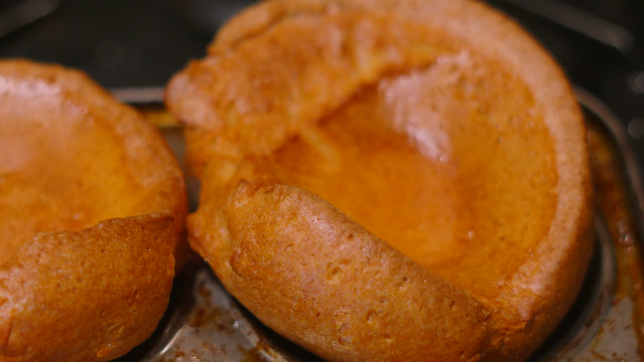 Perfectly Risen British Yorkshire Puddings in Rustic Tray After Cooking in Hot Oven. English Cuisine Traditionally Served at Sunday Lunch or Dinner.