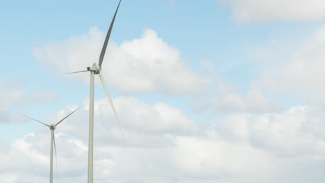 Close-up-view-of-wind-turbines-slowly-moving-in-the-wind