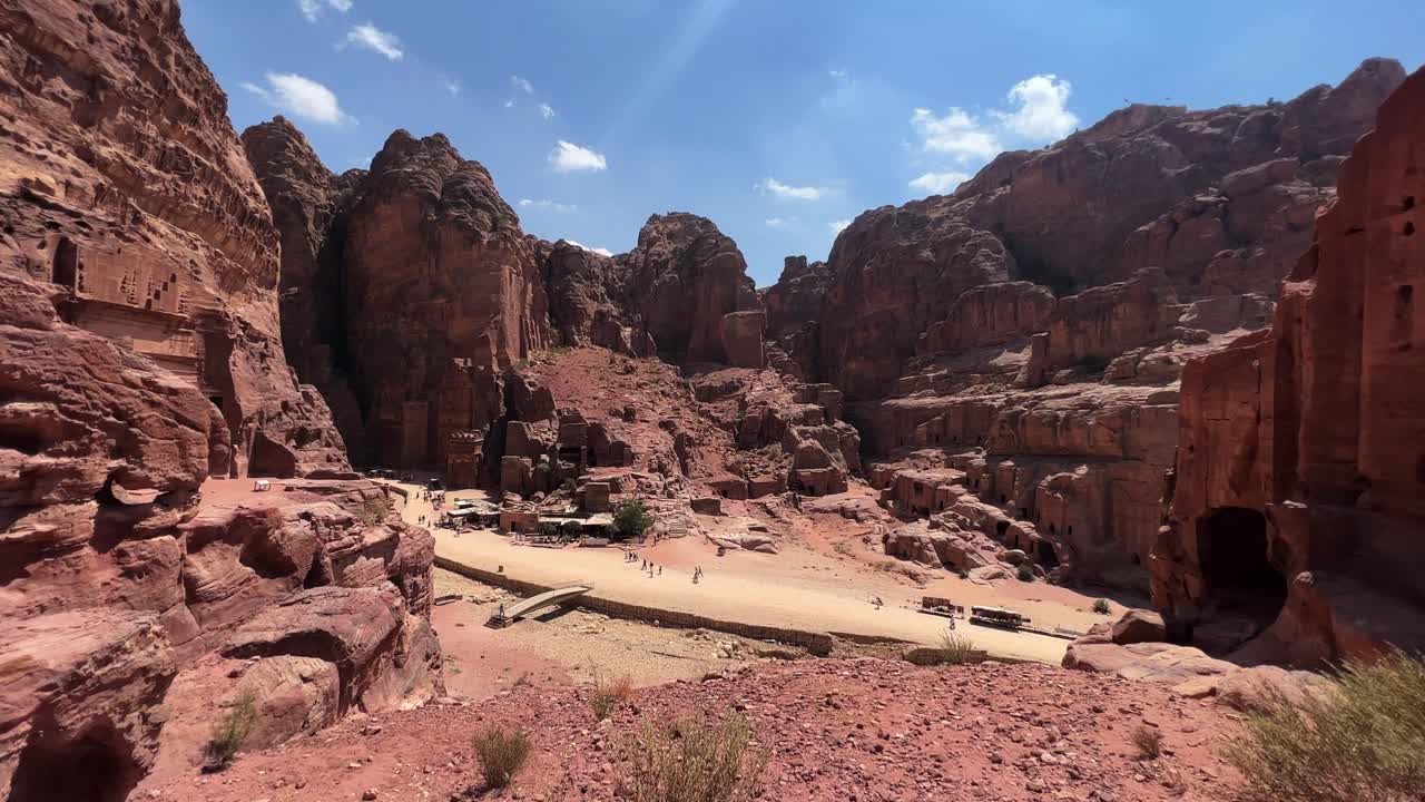 Petra valley in Wadi Musa, Jordan with The Treasury in the middle of a rocky and mountainous landscape, an UNESCO heritage site, ancient Nabatean Kingdom 4K Establish Shot