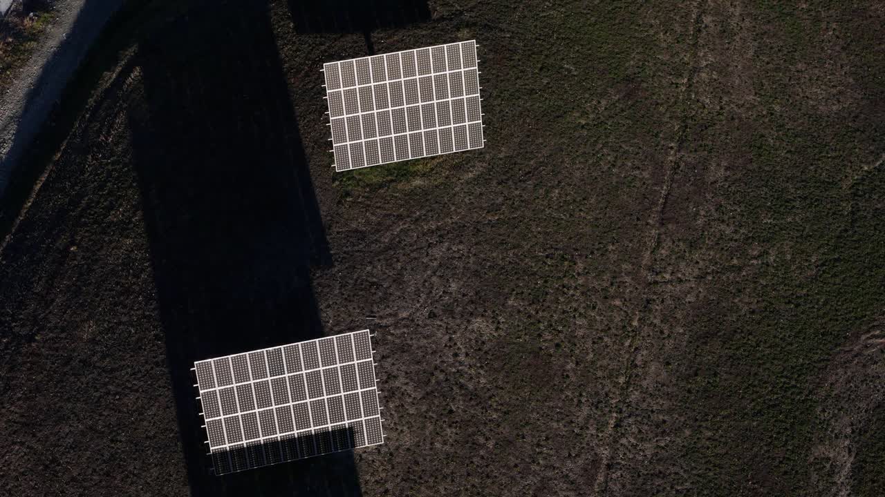 Moduli fotovoltaici installati su un sistema di inseguimento solare a singolo asse che ruota da est a ovest per massimizzare la cattura dell'irradiazione solare all'interno di un impianto di energia rinnovabile a terra, ripresa aerea dall'alto.