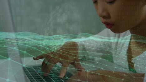 animation of global network and digital landscape over asian girl using laptop
