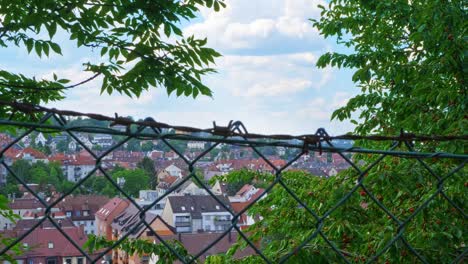 south german town of stuttgart on the hillside behind barbed wire and fence