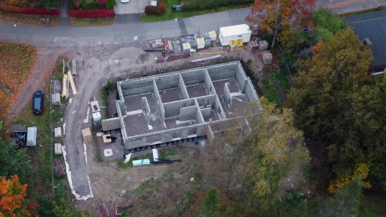 Aerial orbits construction site with concrete building in progress