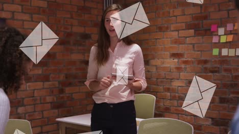 animation of envelopes moving over diverse businesswoman with tablet explaining to colleagues