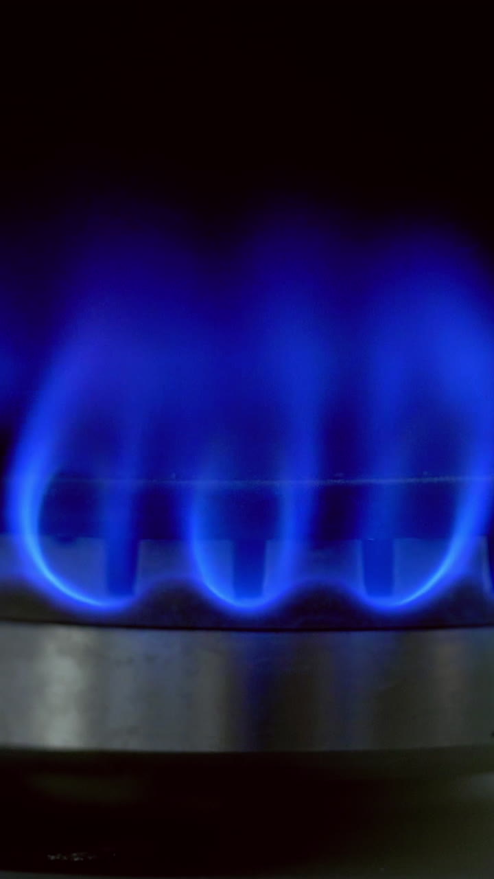 Flame of kitchen gas stove. Kitchen stovetop cook with blue flames propane gas burning