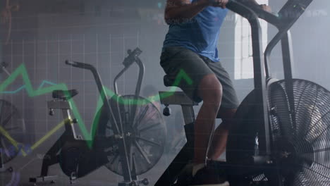 animation of data processing on graph over african american man cross training on elliptical at gym