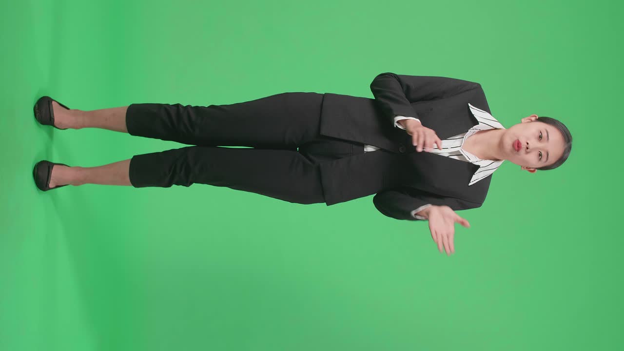 Full Body Of Asian Businesswoman Pointing On Something And Talking On The Green Screen Background