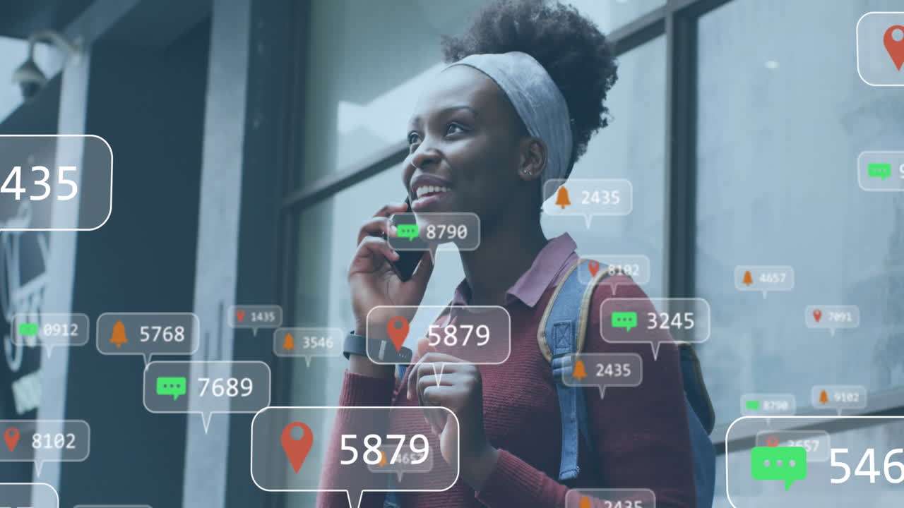 Animation of social media networking icons over african american talking on smartphone outdoors